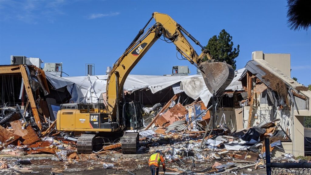 An excavator working on a demolition site