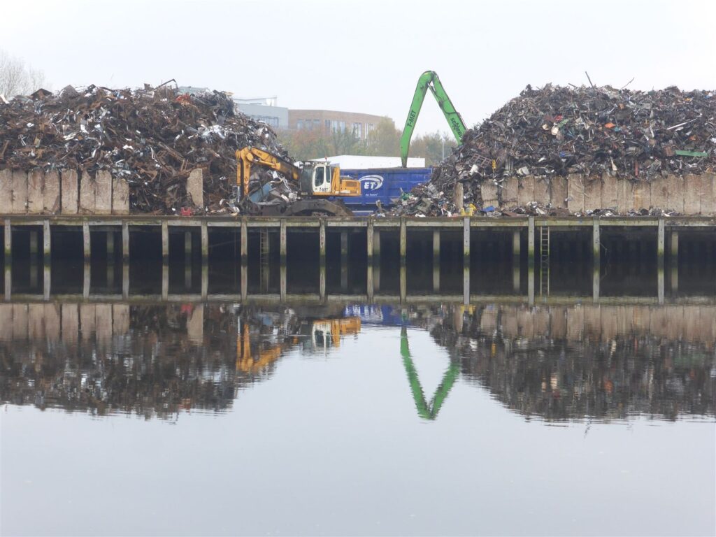 A scrap metal yard with cranes and loaders